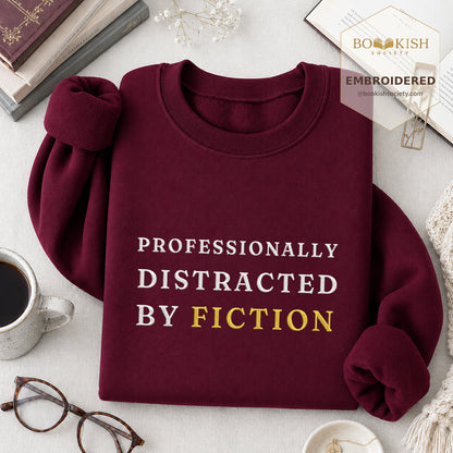 Professionally Distracted By Fiction Embroidered Sweatshirt | Reader Gift Maroon