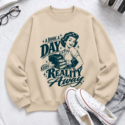 A Book A Day Keeps Reality Away Softstyle Sweatshirt | Cozy Book Lover Gift Sand