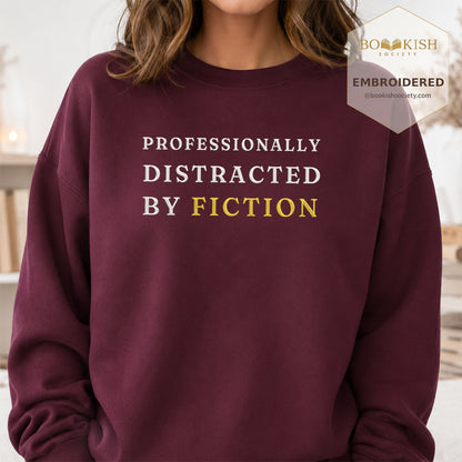 Professionally Distracted By Fiction Embroidered Sweatshirt | Reader Gift Maroon