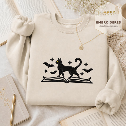 Black Cat Walks On Book Embroidered Sweatshirt | Halloween Book Lover Gift Sand