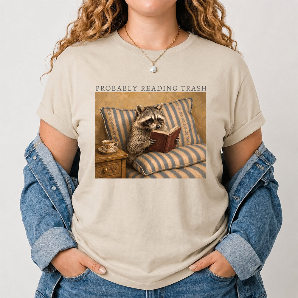 Probably Reading Trash Racoon Softstyle T-Shirt | Book Lover Gift Sand